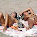 2 girls relaxing at nudist beach